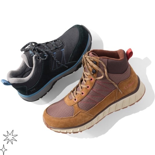 One black low-top hiking shoe with blue accents and one brown mid-height boot with tan sole.