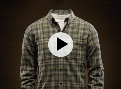 Plaid button-up shirt over white tee on headless mannequin, with play button icon centered on the image. 