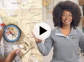 A map and compass on the left, and Stephanie on the right, a play video icon in the center.