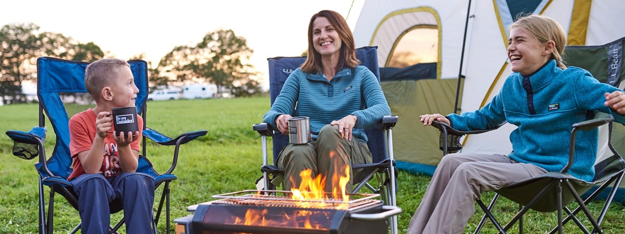 Family gathered around a campfire.