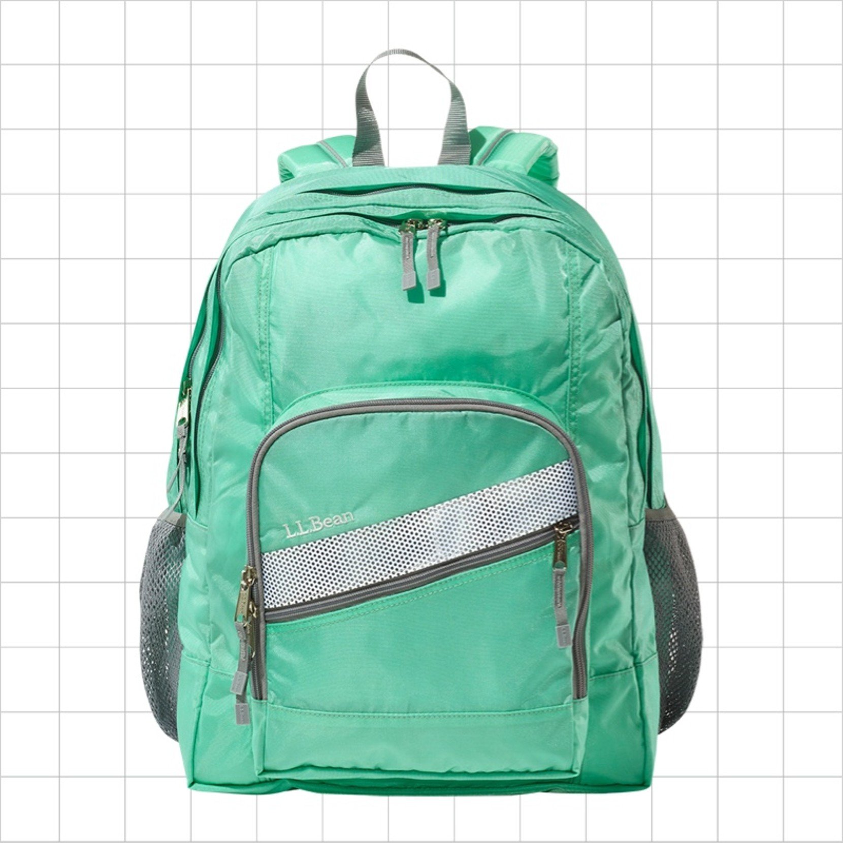 A green school backpack with a diagonal reflective strip on the front pocket.