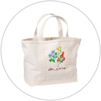 A white canvas tote with embroidery on the front inside of a light gray circle.