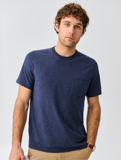 A thigh-up shot of a man wearing a blue t-shirt.