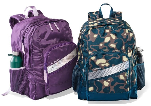 Two school backpacks with water bottles in the side pockets.