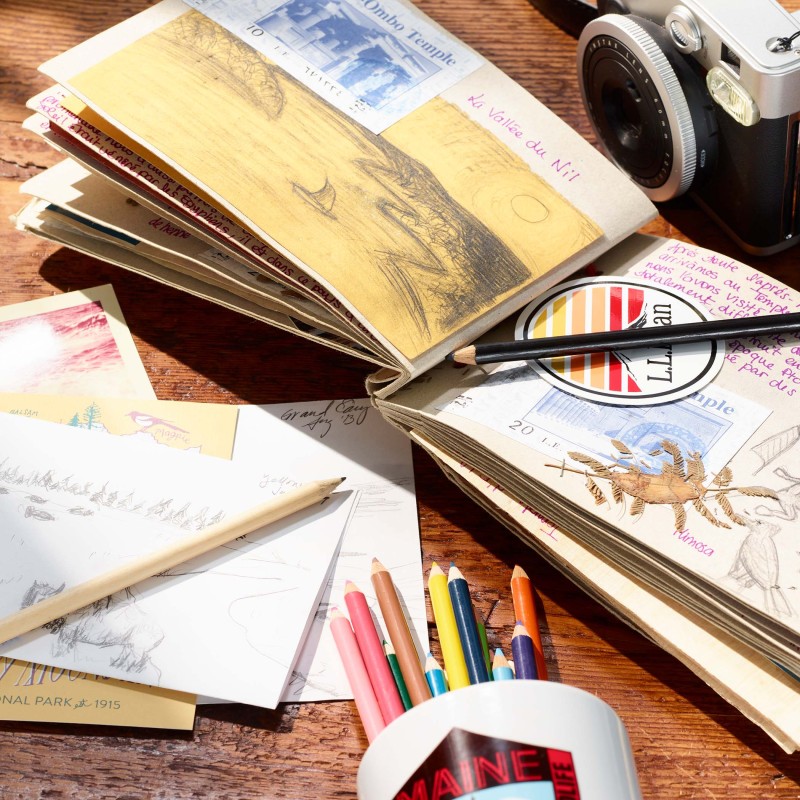 Journal and sketchbook with colored pencils documenting a trip to a national park.