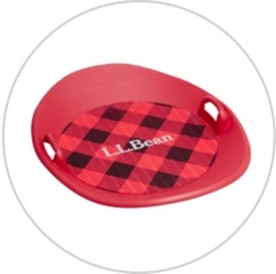 A red buffalo plaid L. L. Bean Sonic Snow Saucer sled.