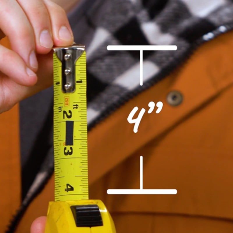 Close-up of someone extending a tape measure to 4 inches.