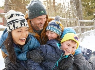 Family of 4 playing in the snow