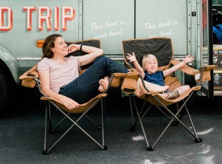 Madison and Margie Bowman in front of the family's converted shuttle bus, Buster.