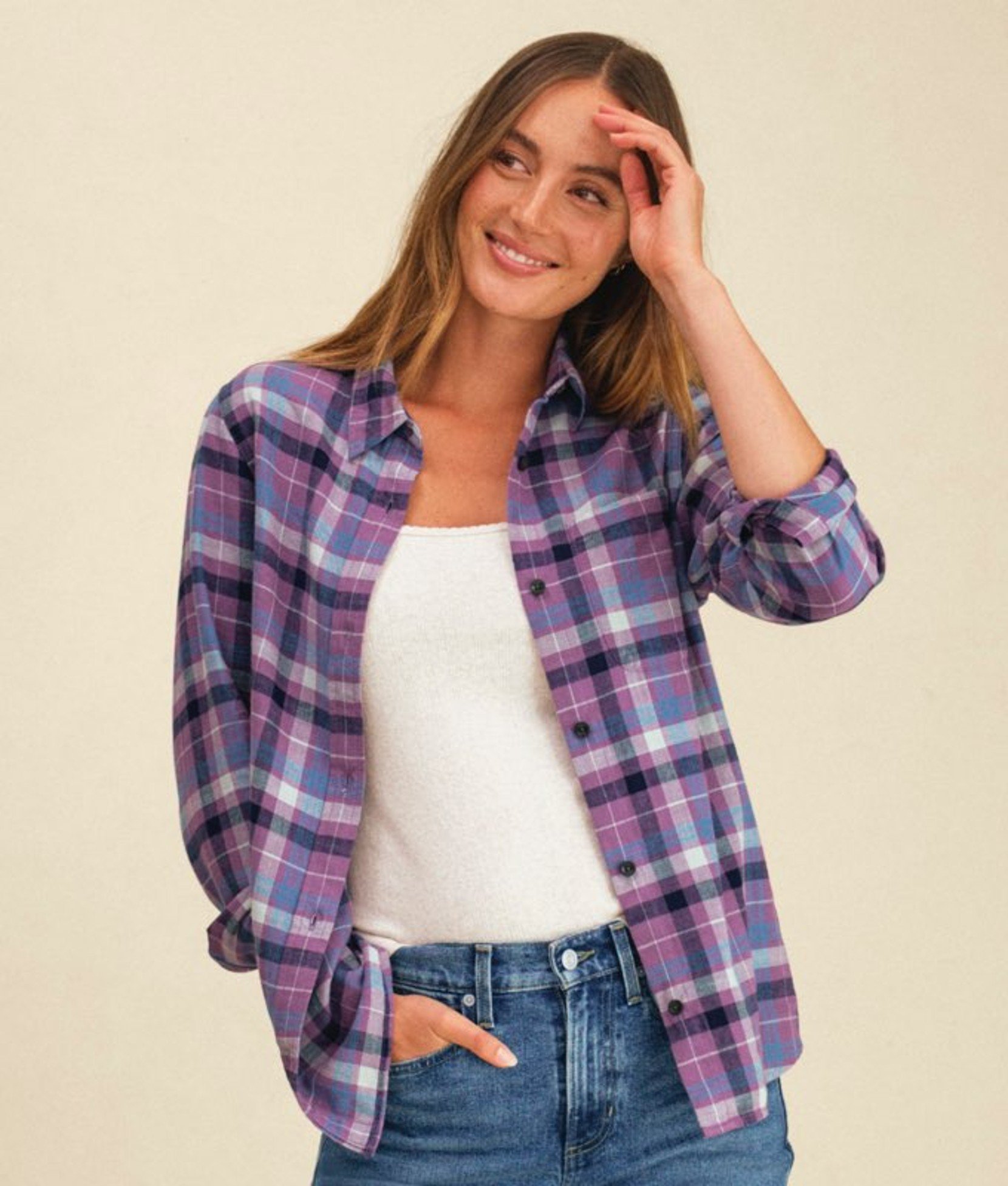 Purple plaid women’s shirt worn open over a white top.