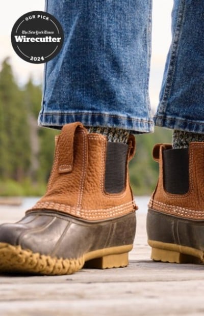 Close up of a person in L. L. Bean boots and jeans standing on a wooden dock and a Wirecutter top pick badge.