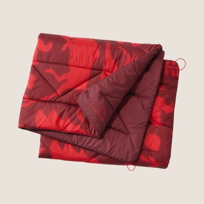 Folded red and maroon sleeping bag with abstract pattern and corner loops