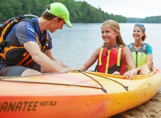 Smiling woman in an L.L.Bean kayak.