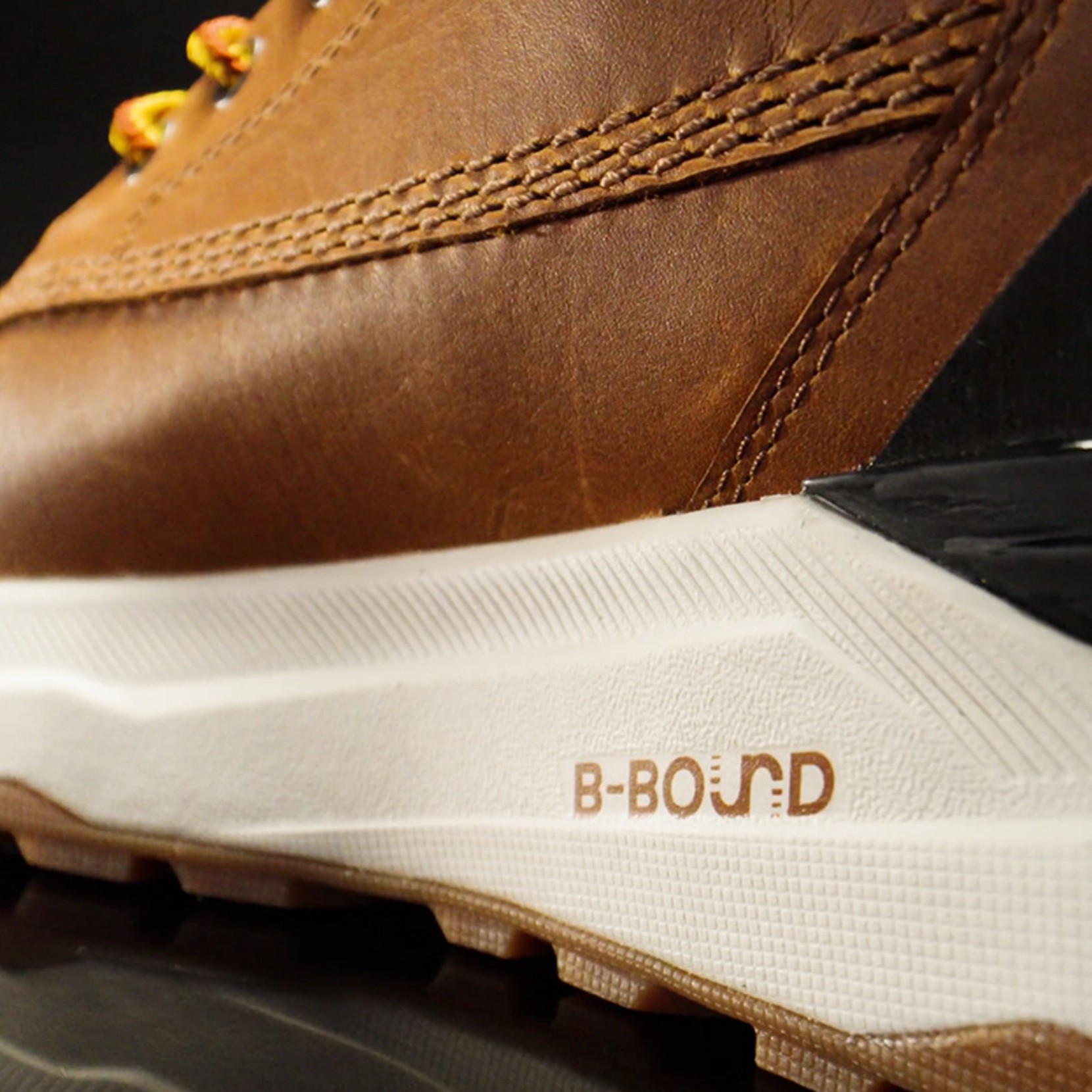 Close-up of brown leather shoe with white sole and 'B-BOUND' branding in brown text on the side.