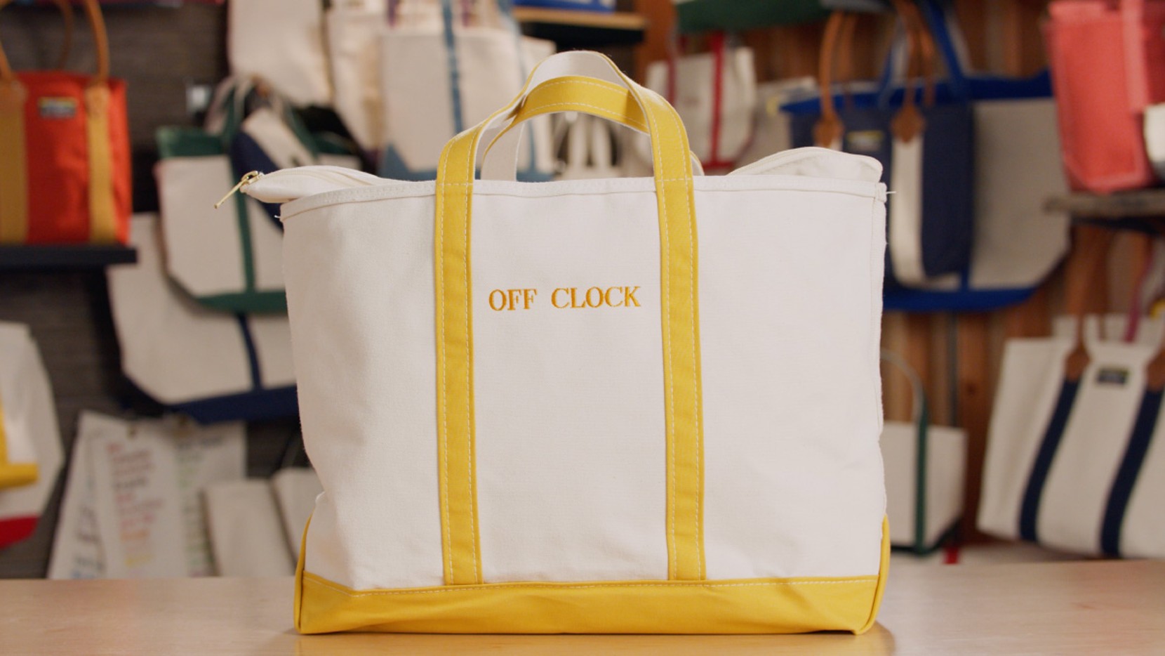 A large zip-top Boat & Tote with yellow handles and monogram - OFF CLOCK