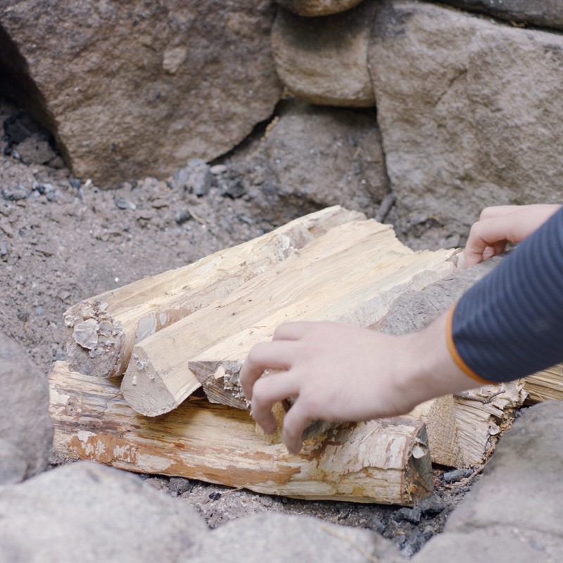 Nate adding a second layer of fuel logs.