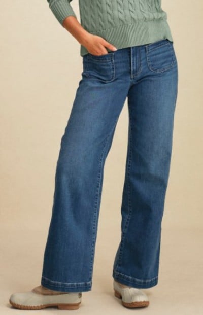 Wide‑leg blue jeans paired with a light sweater and L. L. Bean boots.